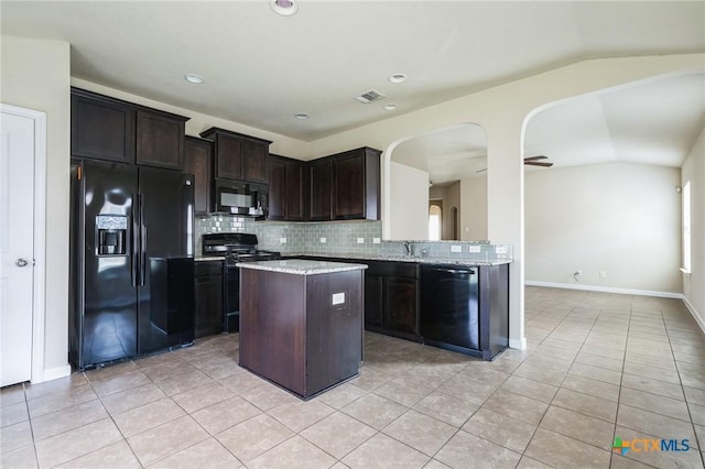 kitchen with lofted ceiling, backsplash, light tile patterned floors, dark brown cabinetry, and black appliances