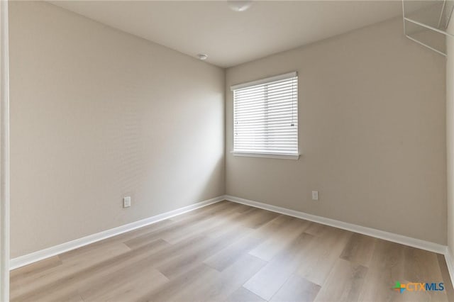 spare room with light hardwood / wood-style flooring