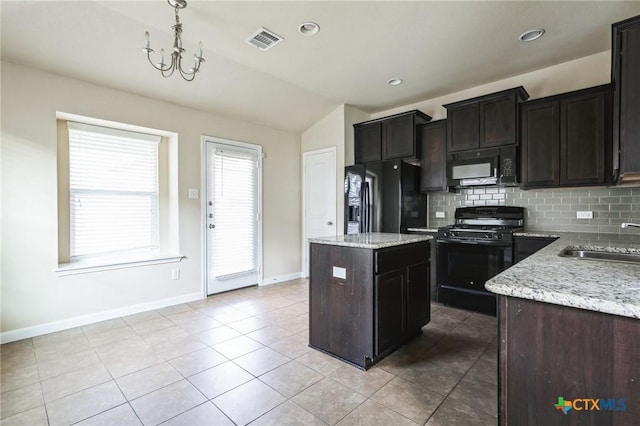 kitchen with sink, decorative light fixtures, black appliances, a kitchen island, and backsplash