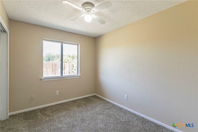 unfurnished room featuring carpet flooring, a textured ceiling, and ceiling fan