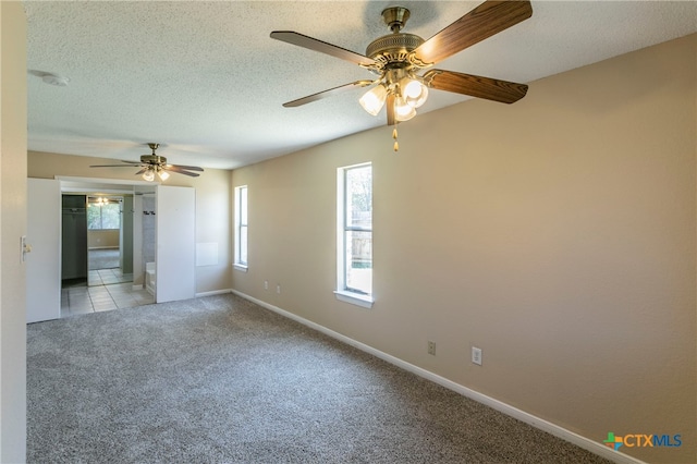 unfurnished room featuring ceiling fan, plenty of natural light, and light carpet