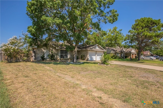 ranch-style house with a garage and a front yard