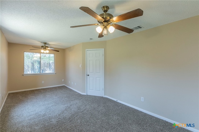 spare room featuring a textured ceiling, ceiling fan, and carpet floors