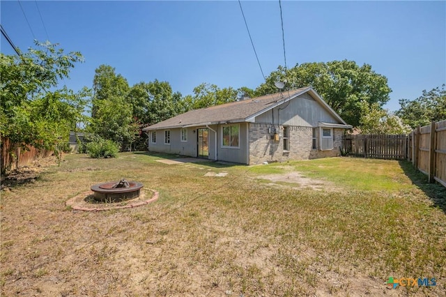 802 Antelope Trl, Temple, TX 76504 - rear view of property with an outdoor fire pit and brick siding