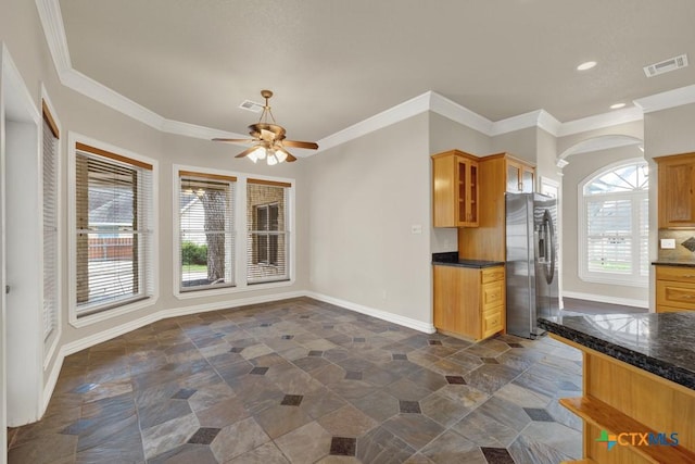 kitchen featuring stainless steel refrigerator with ice dispenser, ceiling fan, and ornamental molding