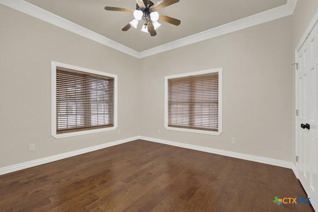 empty room with crown molding, dark wood-type flooring, and ceiling fan