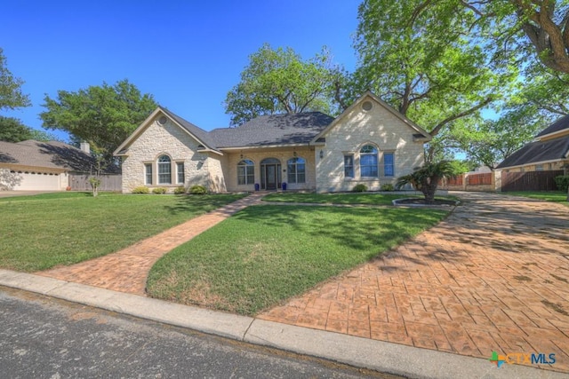 133 Rio Azul, Seguin, TX 78155 - view of front of home with fence, a front lawn, and stone siding