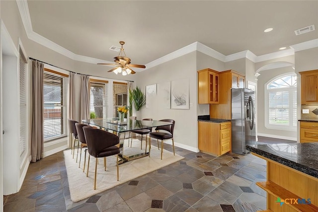 dining room featuring ornamental molding, plenty of natural light, and ceiling fan