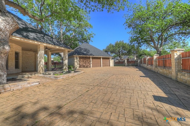 133 Rio Azul, Seguin, TX 78155 - view of patio / terrace featuring a garage, fence private yard, and an outbuilding