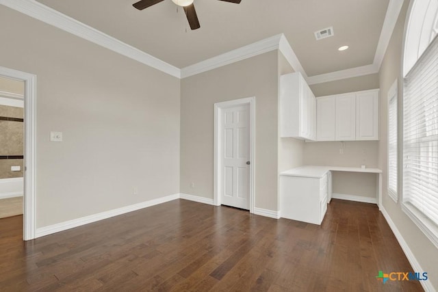 interior space featuring crown molding, ceiling fan, dark hardwood / wood-style flooring, and built in desk