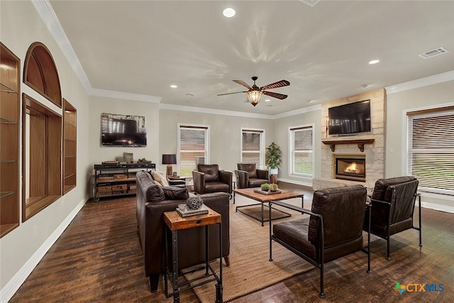 living room featuring crown molding, a fireplace, and dark hardwood / wood-style flooring