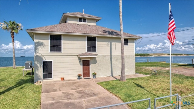 100 Bayshore Drive, Ingleside On The Bay, TX 78362 - traditional-style house with cooling unit, a water view, and a shingled roof