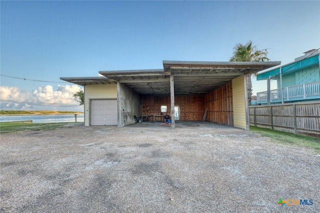 exterior space featuring a water view and a carport