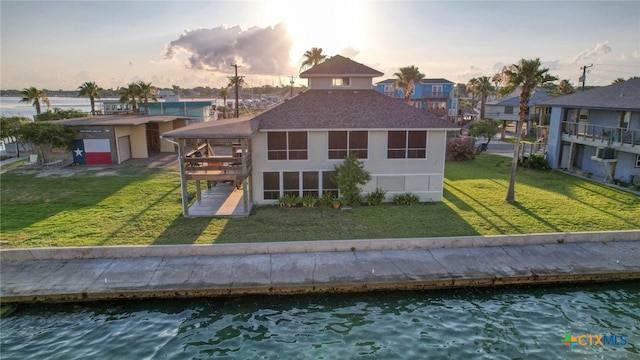 100 Bayshore Drive, Ingleside On The Bay, TX 78362 - rear view of property featuring a lawn, roof with shingles, and a water view