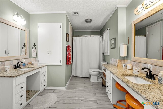 bathroom featuring vanity, a textured ceiling, and crown molding