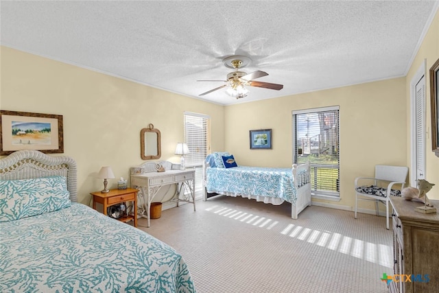 carpeted bedroom featuring a textured ceiling and ceiling fan