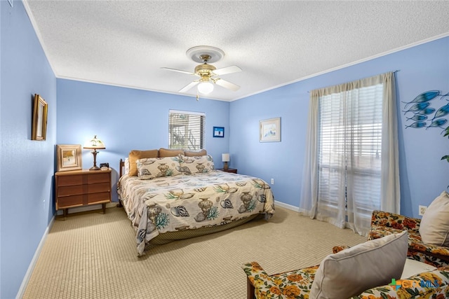 bedroom featuring ornamental molding, a textured ceiling, light carpet, and ceiling fan