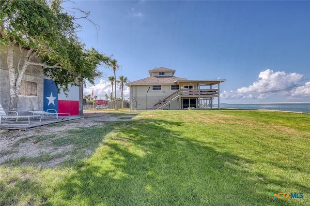 view of yard featuring a deck with water view