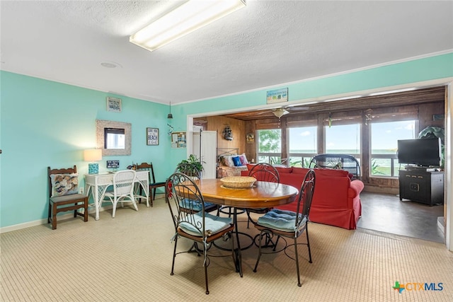 dining room featuring ceiling fan and a textured ceiling