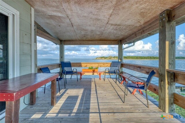 wooden terrace featuring a water view