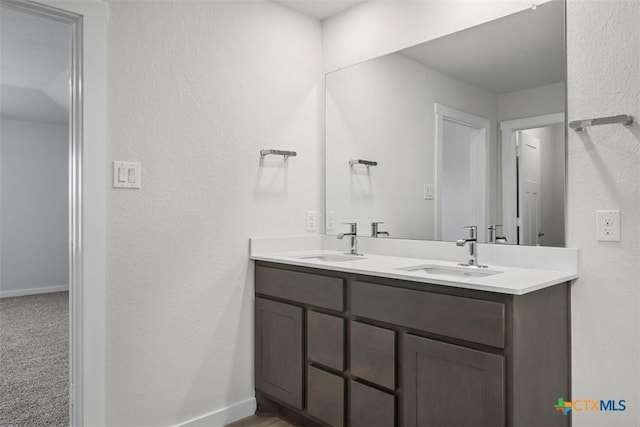 2508 Torbensen Ct, Temple, TX 76504 - bathroom with baseboards, double vanity, and a textured wall