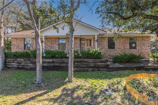 ranch-style home with a front lawn