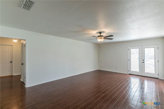 empty room featuring ceiling fan, french doors, and a textured ceiling