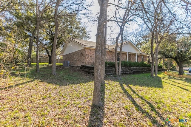 view of property exterior with a yard and cooling unit