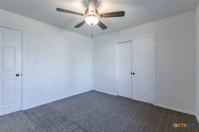 unfurnished bedroom with ceiling fan, a closet, and dark carpet