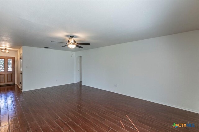 unfurnished room featuring dark hardwood / wood-style floors and ceiling fan