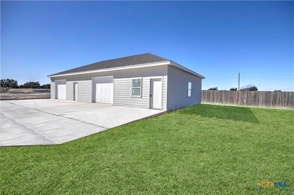 detached garage featuring fence