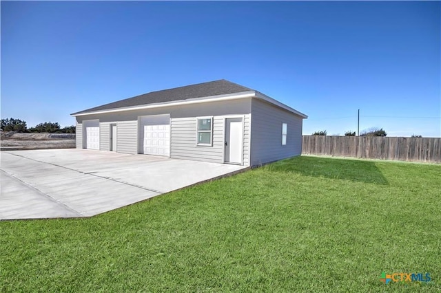 detached garage featuring fence