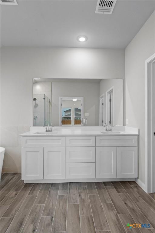 bathroom featuring vanity and shower with separate bathtub