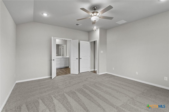 unfurnished bedroom featuring lofted ceiling, carpet floors, and ceiling fan