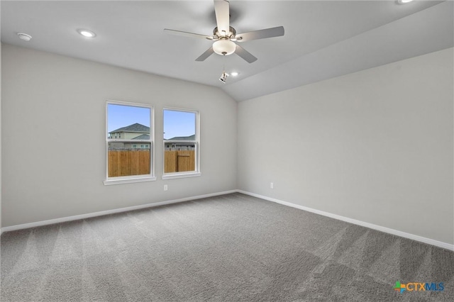 spare room with ceiling fan, lofted ceiling, and carpet floors