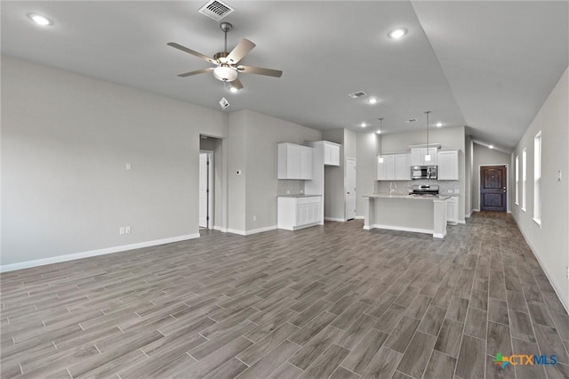 unfurnished living room with lofted ceiling and ceiling fan