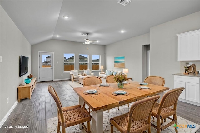 dining area featuring ceiling fan and lofted ceiling