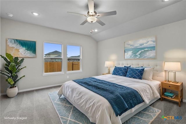 carpeted bedroom with ceiling fan and vaulted ceiling