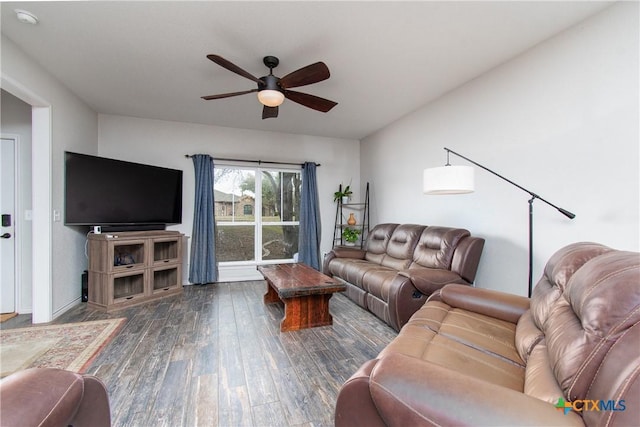 living room featuring ceiling fan and dark hardwood / wood-style floors