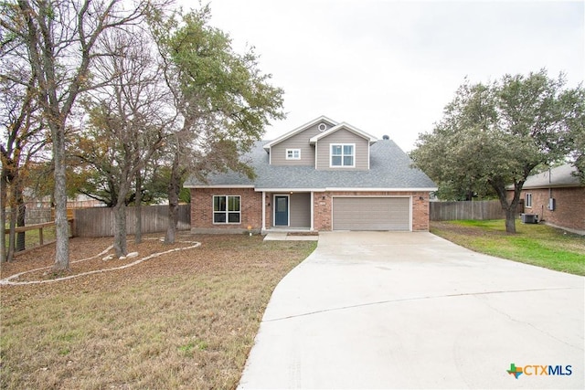 view of front of house with cooling unit, a garage, and a front yard