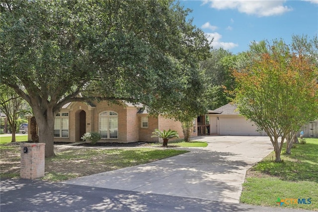 251 Las Brisas Blvd, Seguin, TX 78155 - view of property hidden behind natural elements with driveway, a garage, and a front lawn