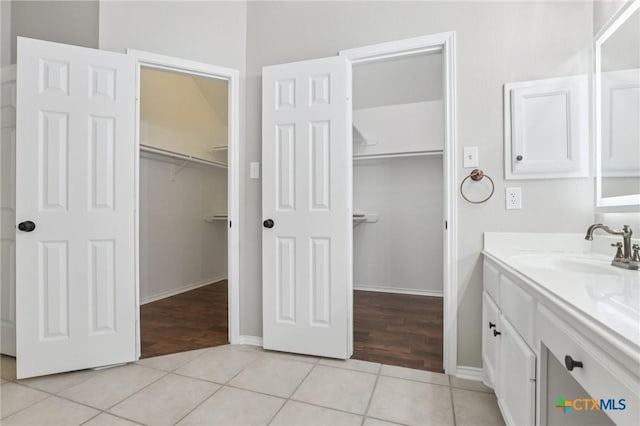 251 Las Brisas Blvd, Seguin, TX 78155 - bathroom featuring vanity, a spacious closet, tile patterned flooring, and baseboards