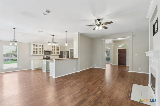 251 Las Brisas Blvd, Seguin, TX 78155 - unfurnished living room featuring ceiling fan, dark wood finished floors, a fireplace with flush hearth, and baseboards