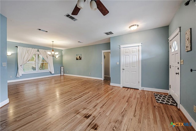 2006 Rose Cir, Harker Heights, TX 76548 - unfurnished living room with a ceiling fan, a chandelier, and light wood-style flooring