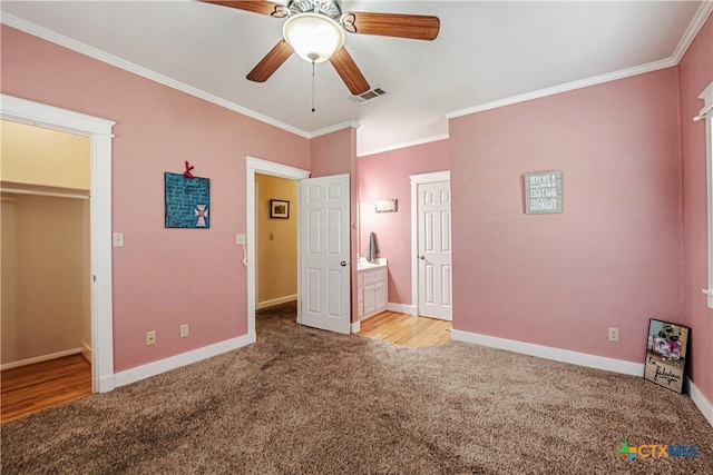 2006 Rose Cir, Harker Heights, TX 76548 - unfurnished bedroom with carpet, ornamental molding, a walk in closet, a closet, and ceiling fan