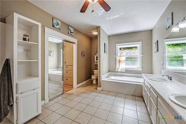 2006 Rose Cir, Harker Heights, TX 76548 - full bathroom featuring a bath, double vanity, a ceiling fan, tile patterned floors, and built in shelves