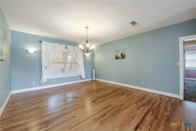 2006 Rose Cir, Harker Heights, TX 76548 - unfurnished room featuring a chandelier and wood finished floors