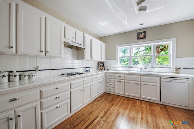 2006 Rose Cir, Harker Heights, TX 76548 - kitchen featuring white appliances, under cabinet range hood, decorative backsplash, white cabinetry, and tile countertops