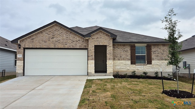 single story home with brick siding, driveway, roof with shingles, a front yard, and an attached garage