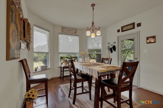 dining room with dark hardwood / wood-style floors, a chandelier, and a wealth of natural light